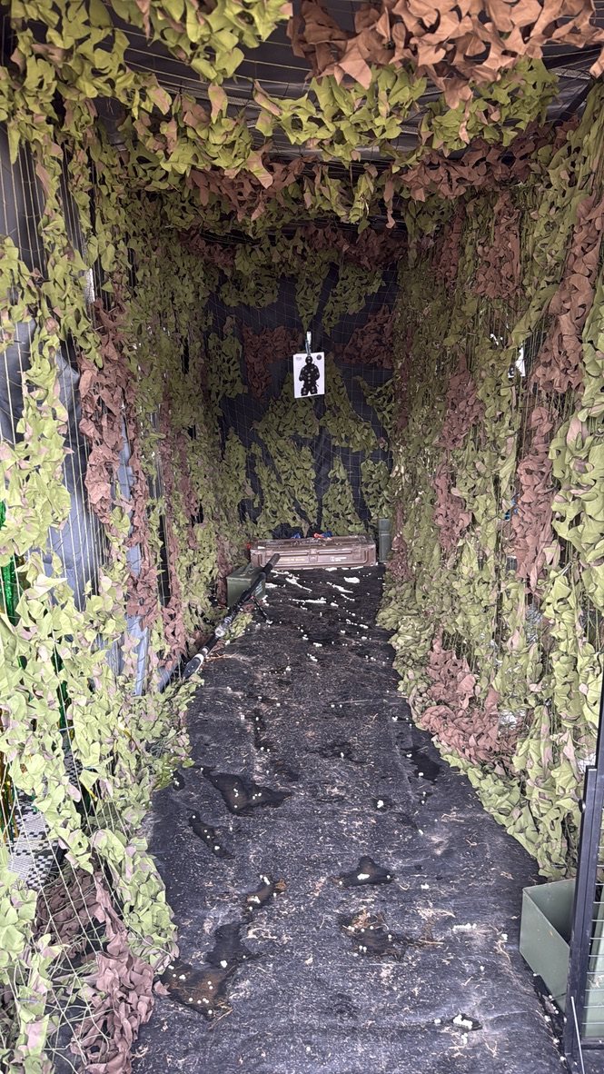 Looking down the enclosed shooting lane at paper targets