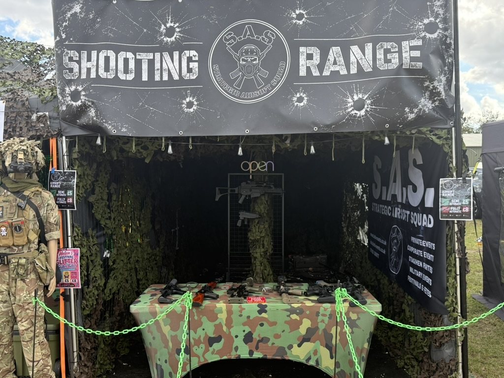 The mobile airsoft range set up and ready, camouflage netting and targets visible