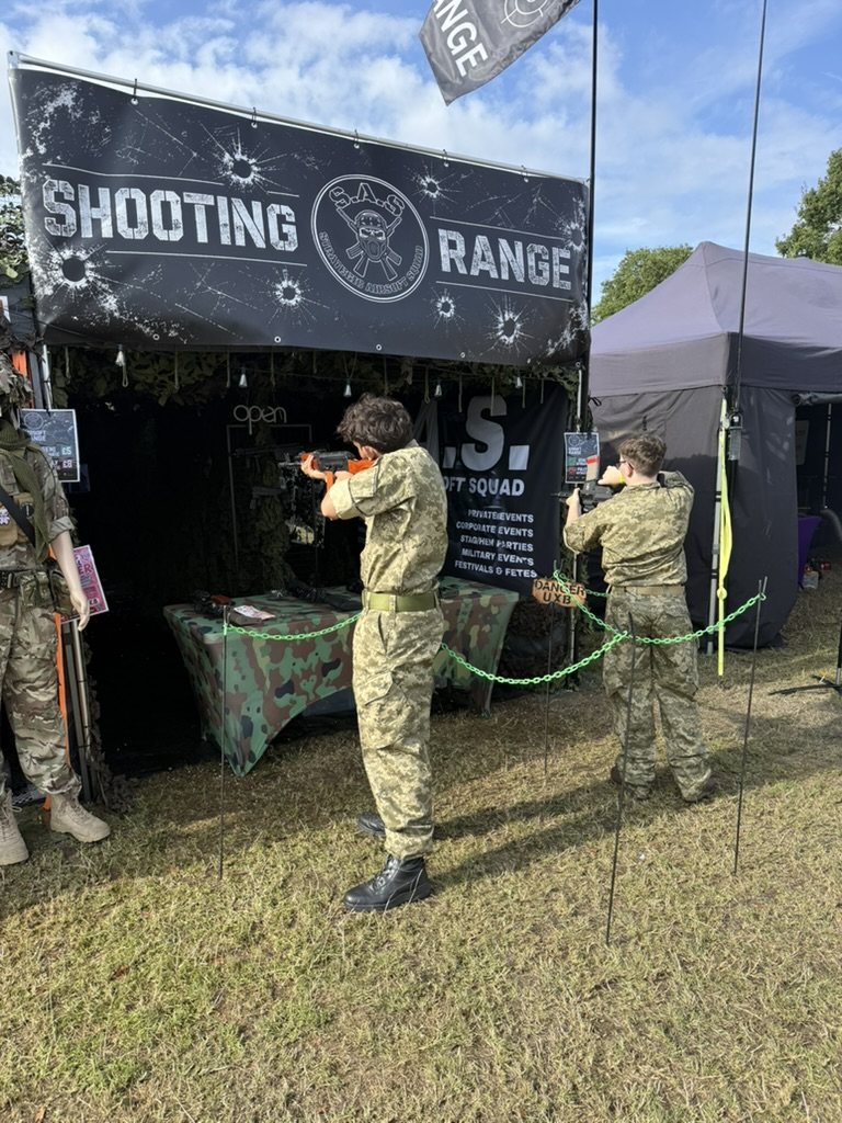 A young shooter taking aim on the mobile airsoft range at a private event